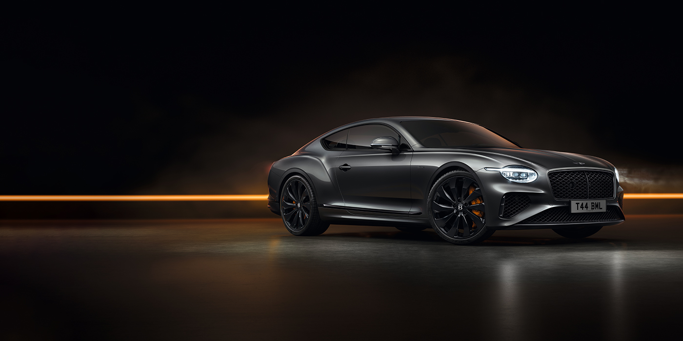 Feser-Graf Exclusive Cars GmbH | Bentley Nürnberg Bentley Continental GT Black Edition coupe front three quarter in Anthracite black paint against a dark grey and copper background