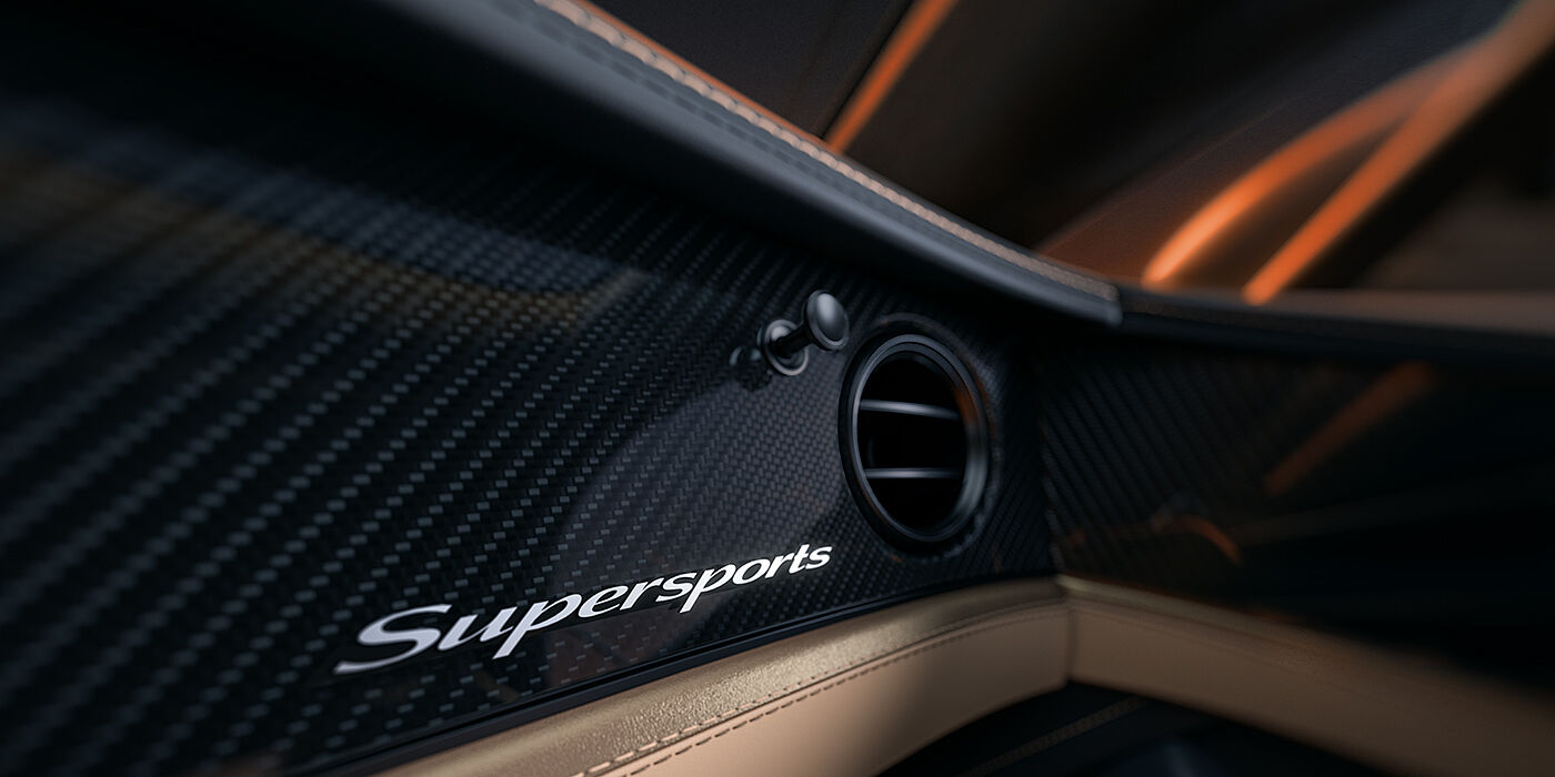 Feser-Graf Exclusive Cars GmbH | Bentley Nürnberg Bentley Supersports front interior high gloss black carbon fibre veneer detail with Supersports badge
