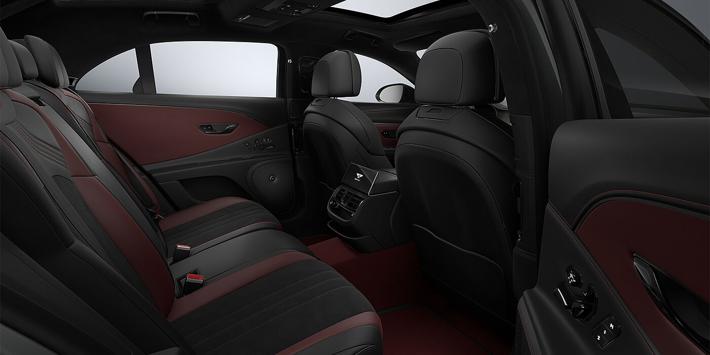 Feser-Graf Exclusive Cars GmbH | Bentley Nürnberg New Bentley Flying Spur S sedan rear interior in Cricket Ball red and Beluga black hides with High Gloss Carbon Fibre veneer