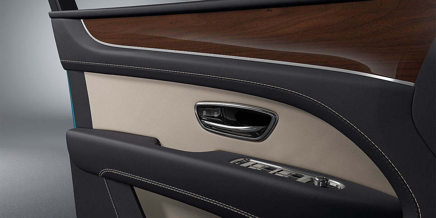 Feser-Graf Exclusive Cars GmbH | Bentley Nürnberg Bentley Bentayga EWB SUV door interior detail in Portland and Imperial Blue hides with Crown Cut Walnut veneer