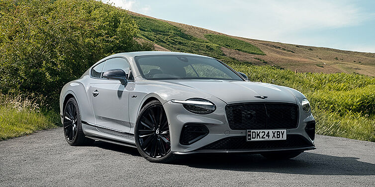 Feser-Graf Exclusive Cars GmbH | Bentley Nürnberg Bentley Continental GT front three quarter with Carbon Fibre Specification parked on road.