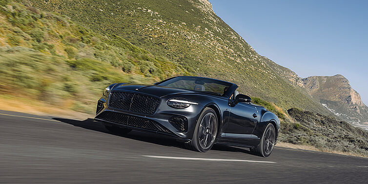 Feser-Graf Exclusive Cars GmbH | Bentley Nürnberg Bentley Continental GTC S Cabrio in Thunder Lackierung, 3/4-Ansicht von vorne, fahrend auf Bergstraße