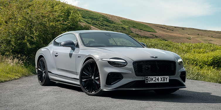 Feser-Graf Exclusive Cars GmbH | Bentley Nürnberg Bentley Continental GT front three quarter with Carbon Fibre Specification parked on road.