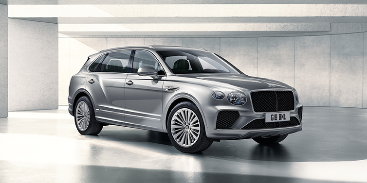 Feser-Graf Exclusive Cars GmbH | Bentley Nürnberg Bentley Bentayga Extended Wheelbase SUV front three quarter in Moonbeam paint with a grey background