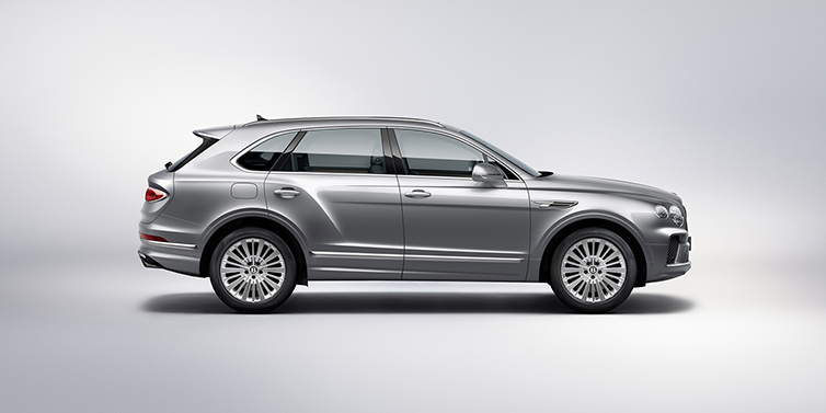 Feser-Graf Exclusive Cars GmbH | Bentley Nürnberg Bentley Bentayga SUV side profile in Moonbeam silver paint against white background featuring 21 inch 5 spoke wheels